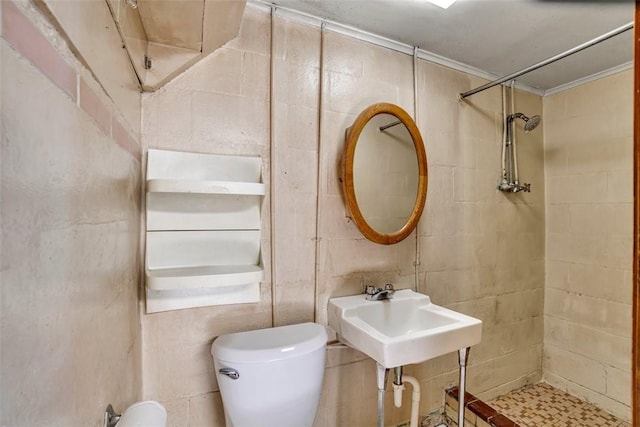 full bath featuring toilet, tiled shower, and tile walls