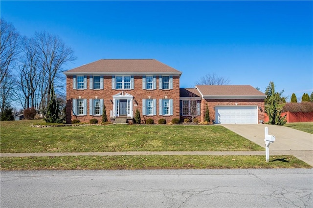 colonial home featuring a garage, brick siding, concrete driveway, and a front yard