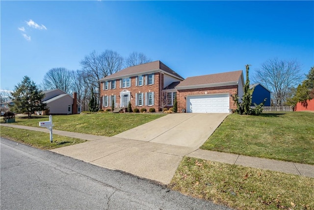 colonial-style house featuring brick siding, an attached garage, driveway, and a front lawn