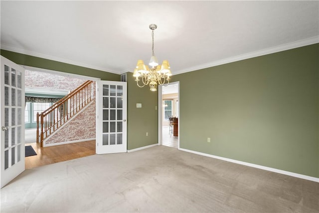 spare room with stairway, baseboards, french doors, crown molding, and a chandelier