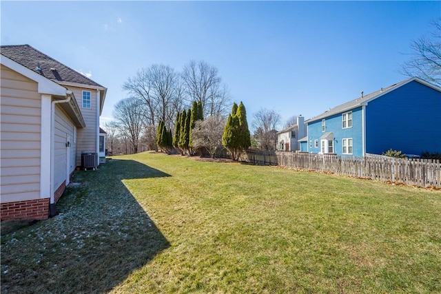 view of yard featuring central air condition unit and fence