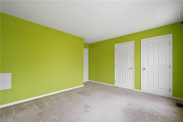 unfurnished bedroom with visible vents, baseboards, and carpet floors