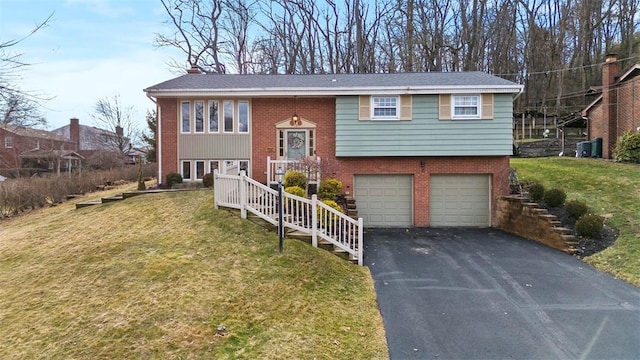 bi-level home with driveway, a front lawn, an attached garage, brick siding, and a chimney