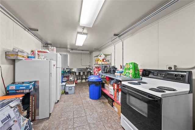 kitchen featuring freestanding refrigerator and electric range oven