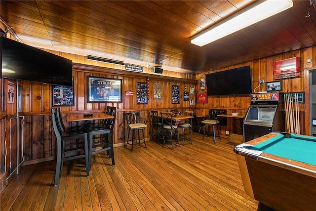 game room featuring wooden walls, wood ceiling, and wood finished floors