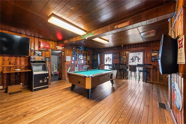 rec room with visible vents, wooden ceiling, a bar, and hardwood / wood-style flooring