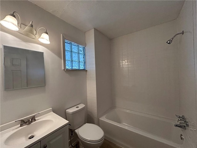 bathroom featuring toilet, shower / tub combination, vanity, and a textured ceiling