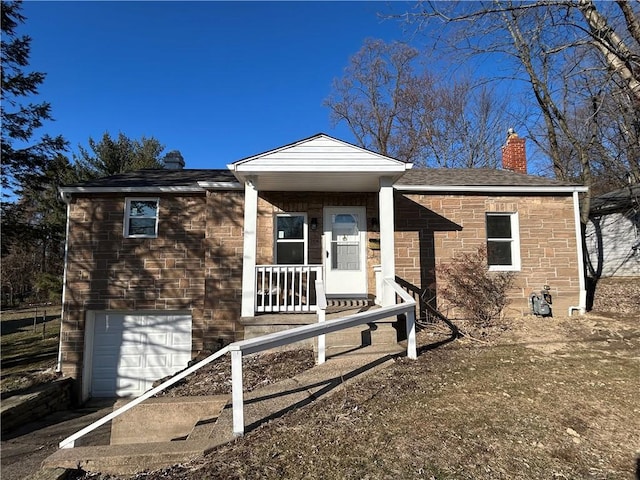 view of front of home featuring covered porch, a chimney, a garage, and a shingled roof