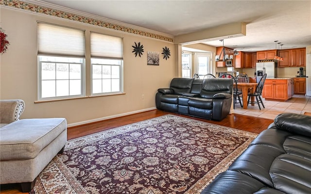 living room with baseboards and light wood-style flooring