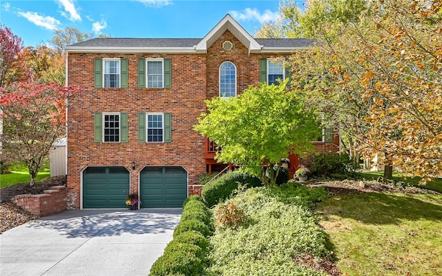 colonial home with brick siding, concrete driveway, and a garage