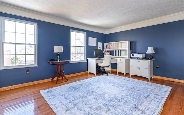 office area with plenty of natural light, a textured ceiling, and wood finished floors