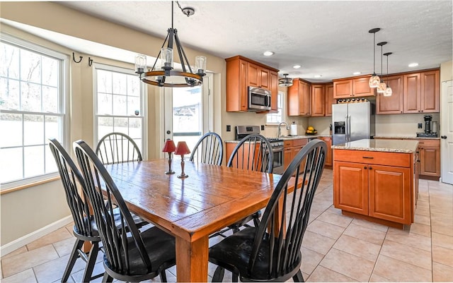 dining space with light tile patterned floors, recessed lighting, baseboards, and a textured ceiling