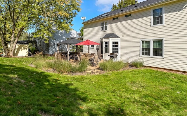 back of house with a patio area and a lawn