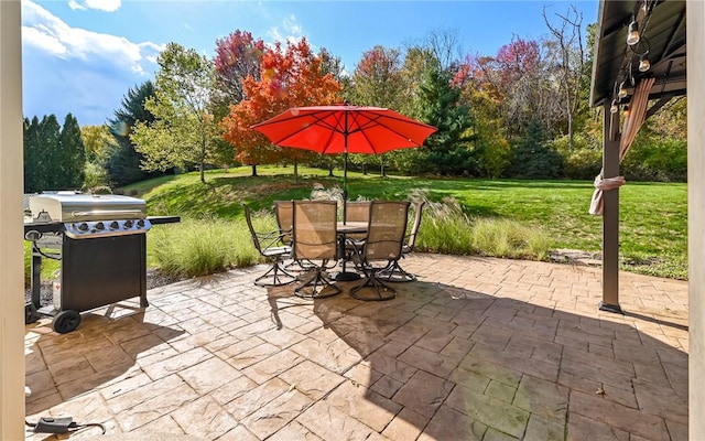 view of patio with outdoor dining area and a grill