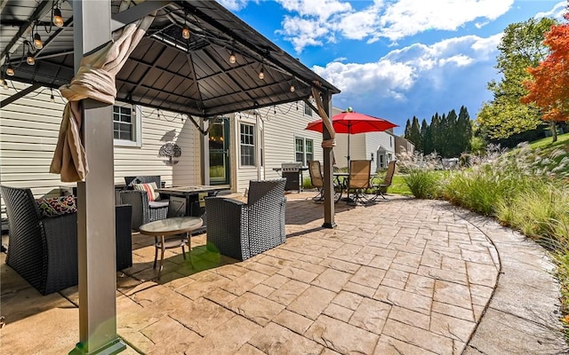 view of patio with a gazebo, outdoor dining area, and area for grilling