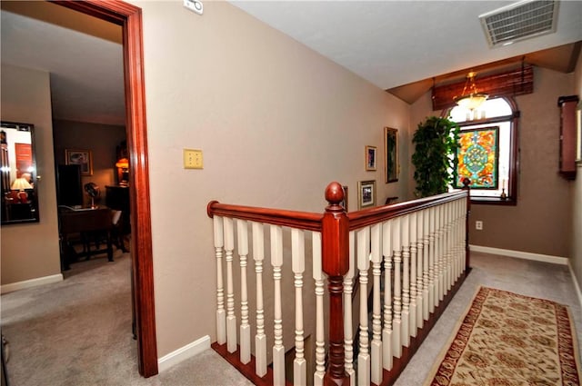 hall featuring carpet flooring, baseboards, and visible vents