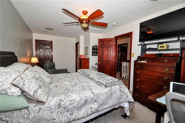 bedroom with a ceiling fan and carpet floors