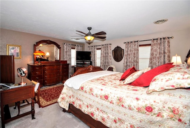 bedroom featuring visible vents, carpet flooring, and ceiling fan