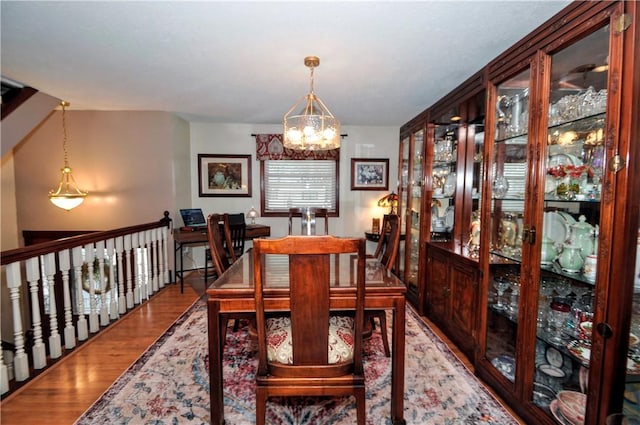 dining area with an inviting chandelier and wood finished floors