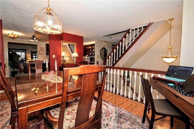 dining room with wood finished floors and stairs