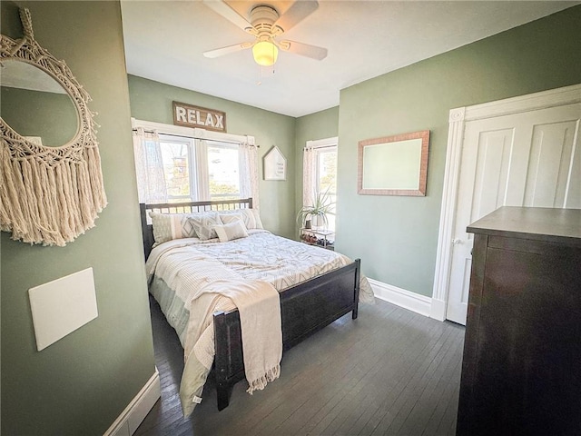 bedroom with a ceiling fan, baseboards, and wood-type flooring