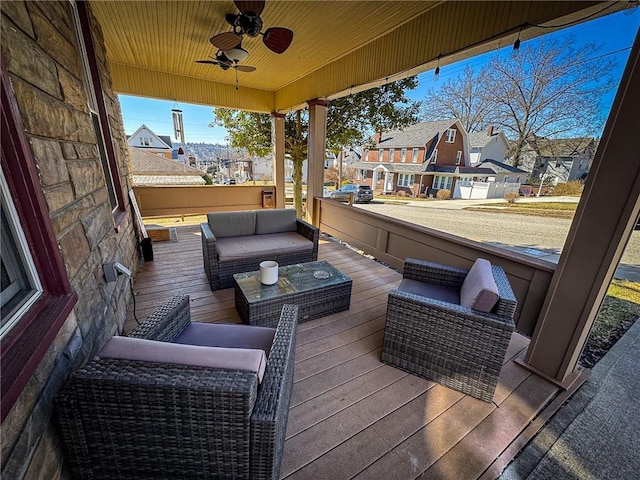 deck with an outdoor hangout area, covered porch, a residential view, and ceiling fan