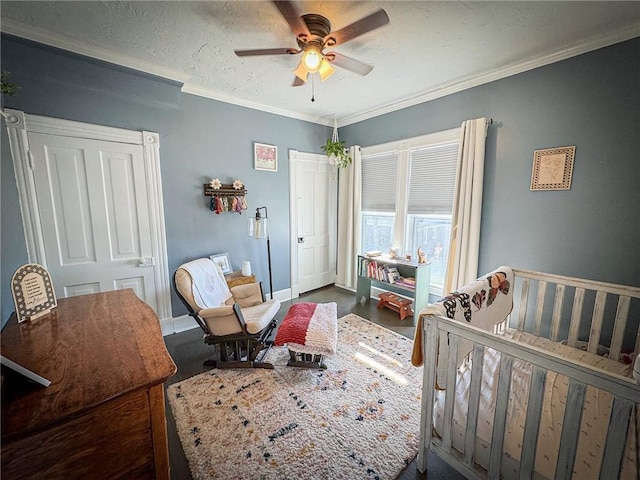 bedroom featuring a textured ceiling, ceiling fan, baseboards, and ornamental molding