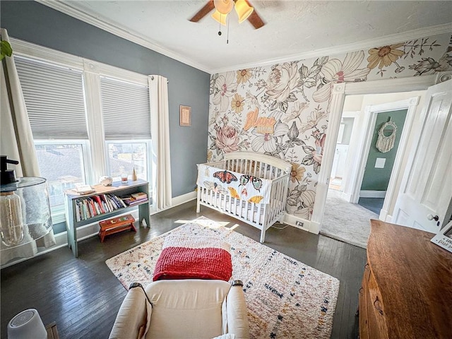 bedroom with ornamental molding, hardwood / wood-style flooring, wallpapered walls, baseboards, and ceiling fan