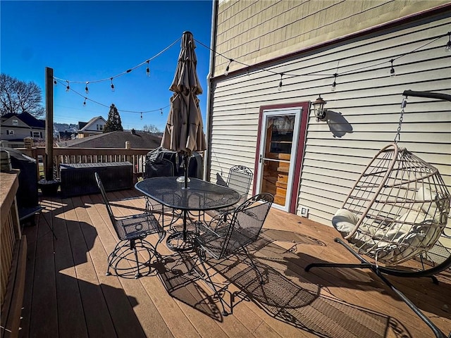 wooden terrace with outdoor dining area