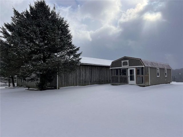 exterior space with a gambrel roof and an outdoor structure