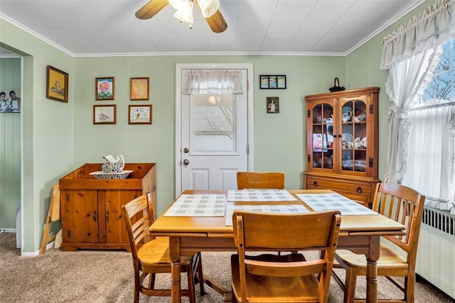 dining space with a wealth of natural light, radiator, and carpet floors