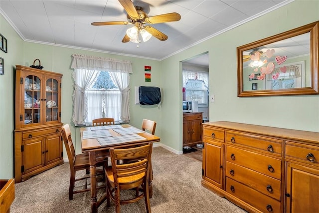 dining space featuring light colored carpet and ornamental molding