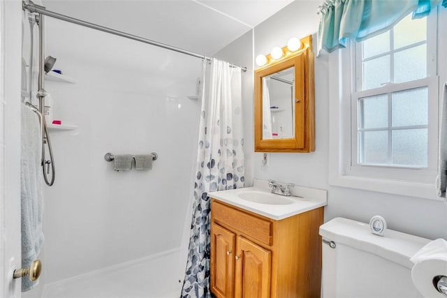 bathroom featuring toilet, a shower with curtain, and vanity