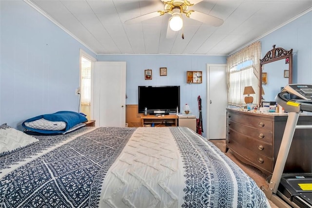 bedroom with a ceiling fan and ornamental molding