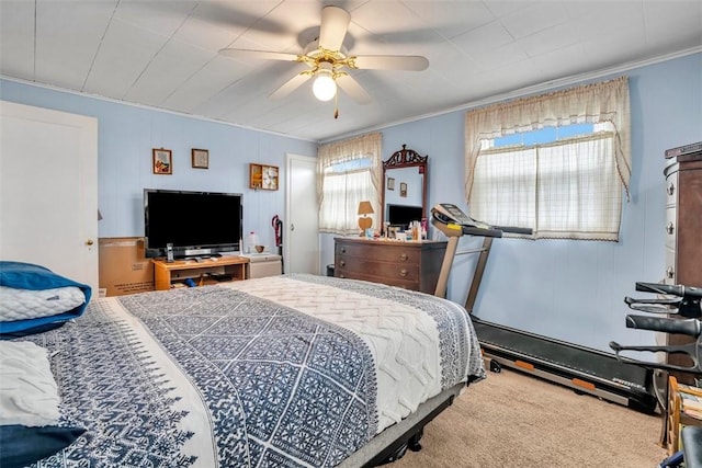 carpeted bedroom with ceiling fan and crown molding