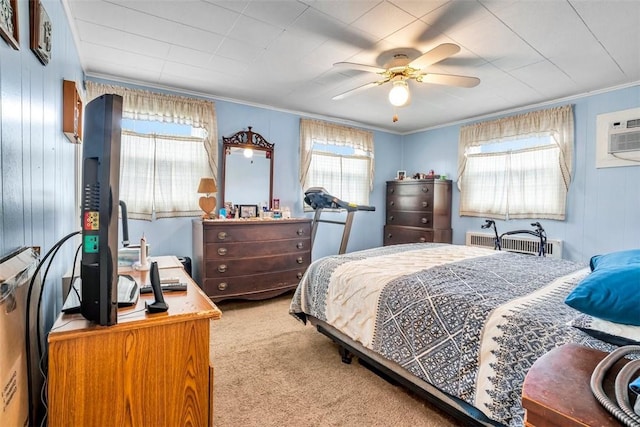 carpeted bedroom featuring ceiling fan, an AC wall unit, radiator heating unit, and ornamental molding