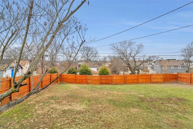 view of yard featuring a residential view and a fenced backyard