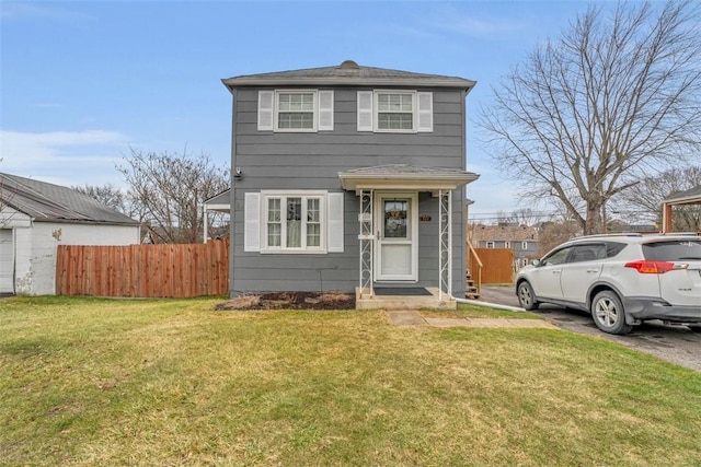 view of front facade featuring a front yard and fence