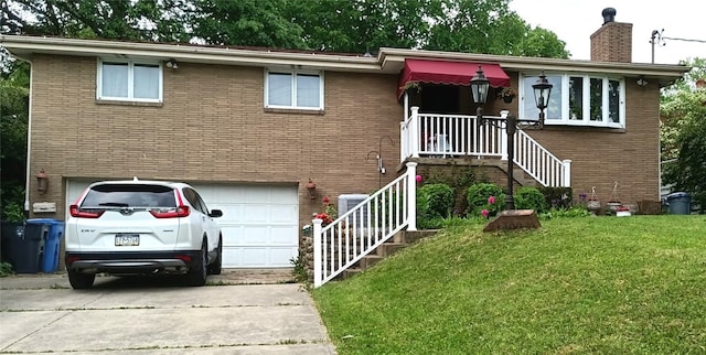 view of front of property featuring a garage, a front yard, brick siding, and driveway