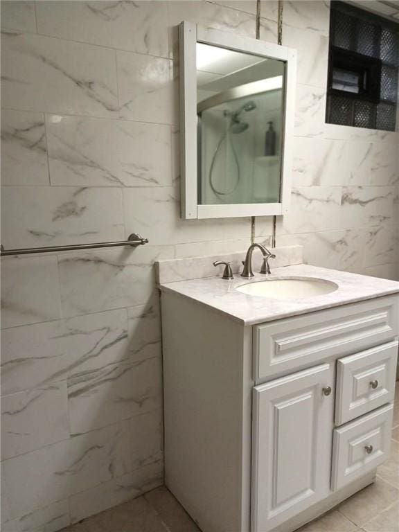 bathroom featuring walk in shower and vanity