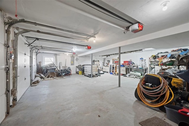 garage featuring electric panel and a garage door opener