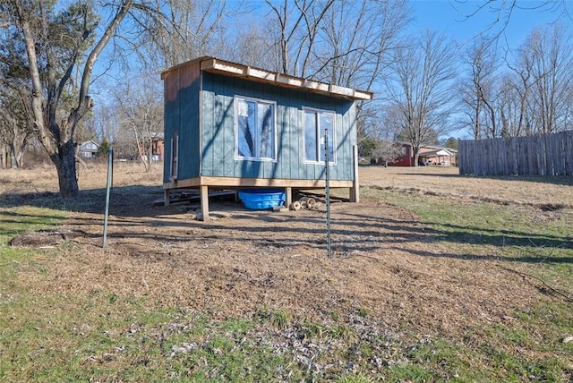 view of outdoor structure with an outbuilding and fence