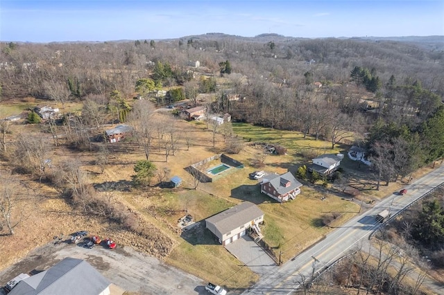 birds eye view of property with a wooded view