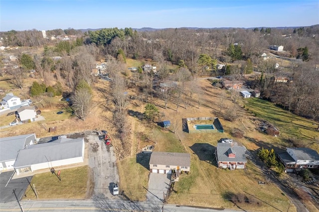 drone / aerial view featuring a wooded view