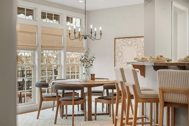 dining space with a healthy amount of sunlight and an inviting chandelier