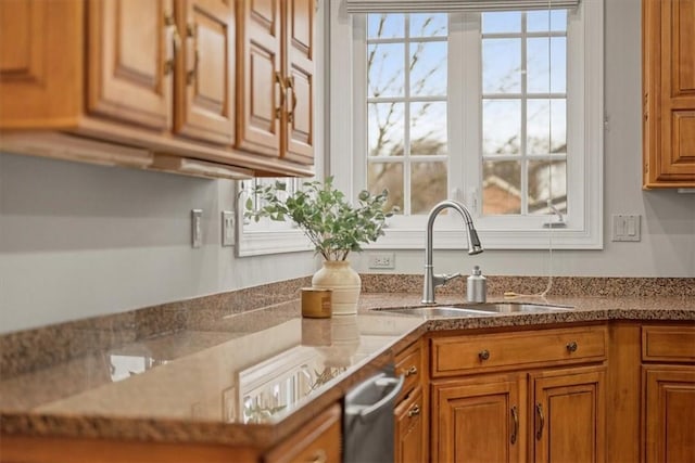 kitchen with plenty of natural light, brown cabinets, and a sink