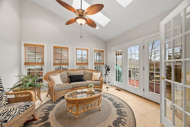 sunroom with lofted ceiling with skylight, visible vents, and ceiling fan