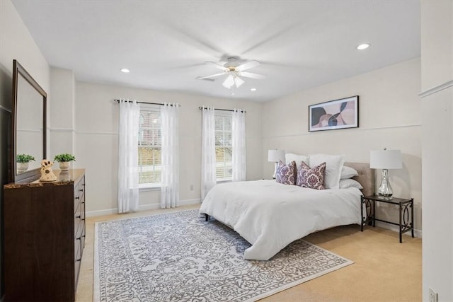 bedroom with recessed lighting, light colored carpet, baseboards, and ceiling fan