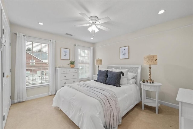 bedroom featuring light carpet, visible vents, recessed lighting, and baseboards