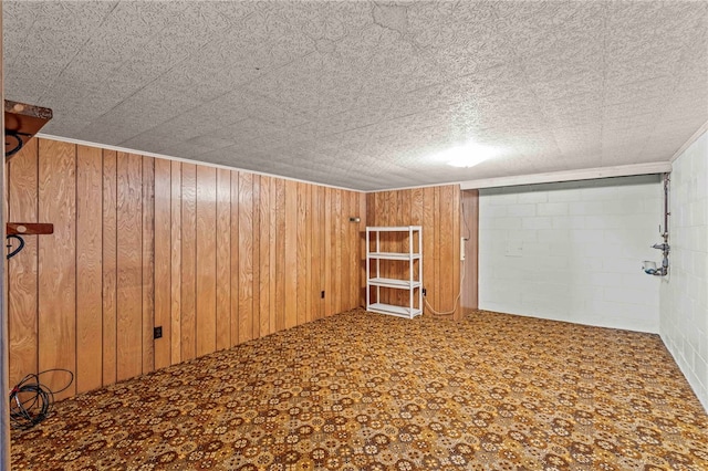 empty room featuring wood walls and concrete block wall